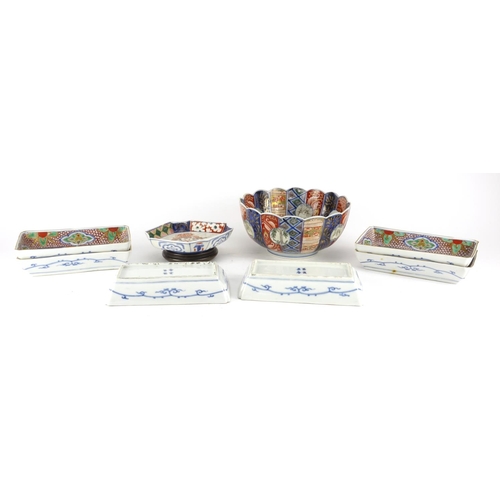 2383 - Japanese Imari porcelain including a fluted bowl and six rectangular dishes, the bowl hand painted w... 
