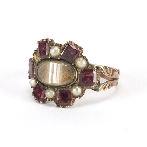 747 - Antique unmarked gold garnet and seed pearl mourning ring, with indistinct inscription to the unders... 