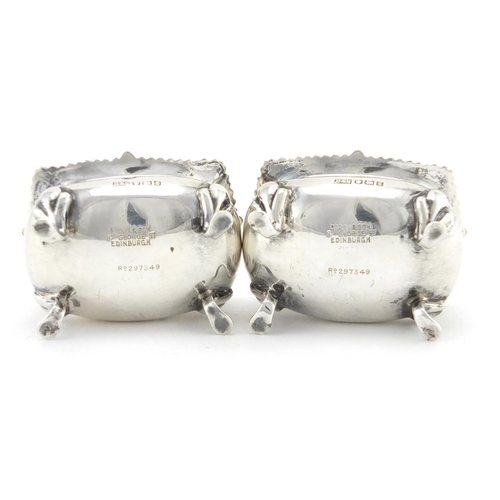 2586 - Pair of silver four footed open salts, with blue glass liners, by Brook & Son, Sheffield 1915, each ... 
