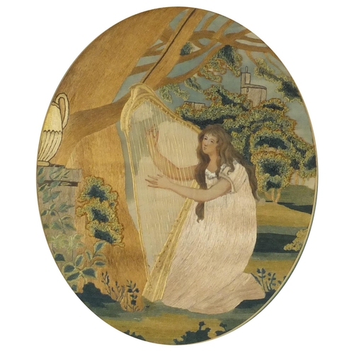 63 - Georgian oval silk wool work picture depicting a girl playing a harp before a castle, mounted and fr... 