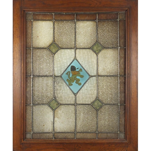 544 - Pair of Arts & Crafts stained glass windows housed in oak frames, each overall 69cm x 56.5cm