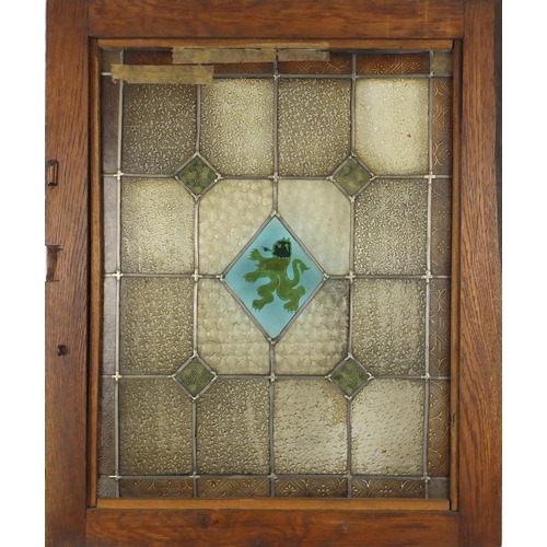 544 - Pair of Arts & Crafts stained glass windows housed in oak frames, each overall 69cm x 56.5cm