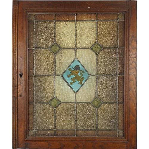 544 - Pair of Arts & Crafts stained glass windows housed in oak frames, each overall 69cm x 56.5cm