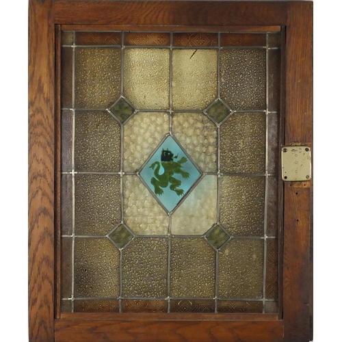 544 - Pair of Arts & Crafts stained glass windows housed in oak frames, each overall 69cm x 56.5cm