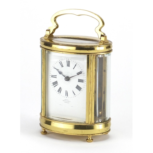 817 - Oval brass cased carriage clock retailed by Asprey of Bond Street London, with fitted leather travel... 
