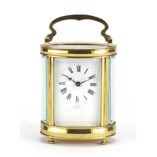 817 - Oval brass cased carriage clock retailed by Asprey of Bond Street London, with fitted leather travel... 