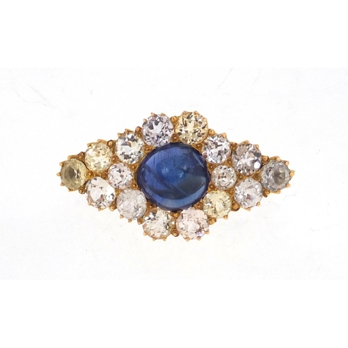 708 - Unmarked gold white sapphire cluster brooch set with a central cabochon blue sapphire, 2.8cm wide, a... 