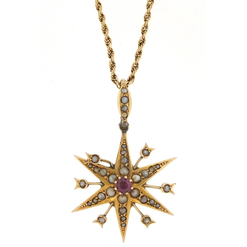 689 - 9ct gold seed pearl starburst pendant set with a central pink stone, on a 9ct gold rope twist neckla... 