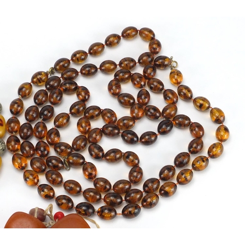 768 - Five amber coloured bead necklaces, approximate weight 670.0g