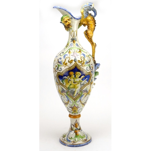 425 - Italian Majolica ewer in the style of Cantagalli, hand painted with putti and griffins, 66.5cm high