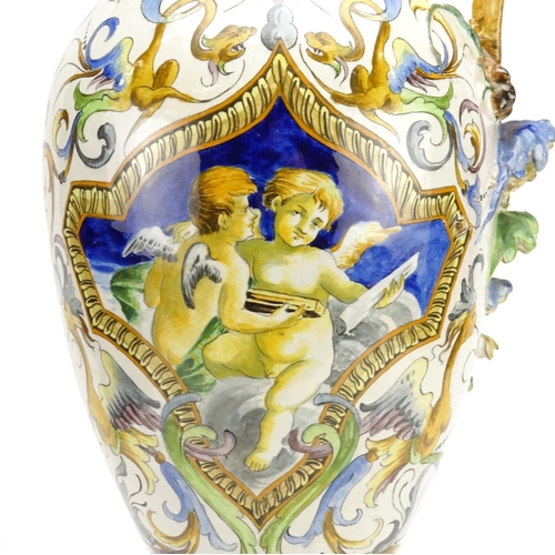 425 - Italian Majolica ewer in the style of Cantagalli, hand painted with putti and griffins, 66.5cm high