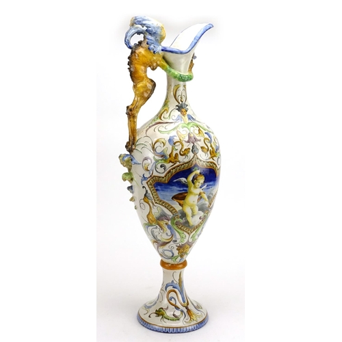 425 - Italian Majolica ewer in the style of Cantagalli, hand painted with putti and griffins, 66.5cm high