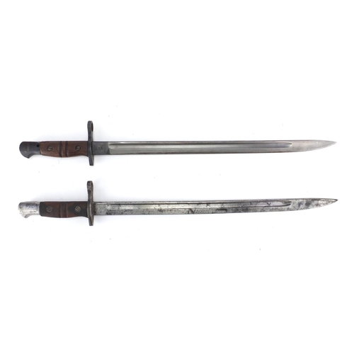 231 - Two American Military interest bayonets with scabbards and leather frogs, impressed marks to the bla... 