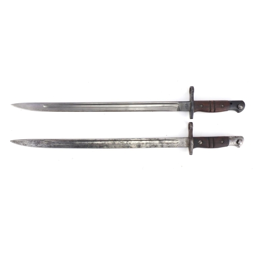 231 - Two American Military interest bayonets with scabbards and leather frogs, impressed marks to the bla... 