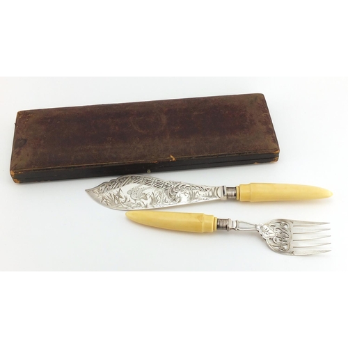 633 - Pair of Victorian fish servers with silver finials and ivory handles, the blade engraved with a hero... 