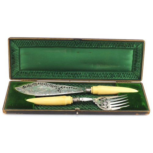 633 - Pair of Victorian fish servers with silver finials and ivory handles, the blade engraved with a hero... 