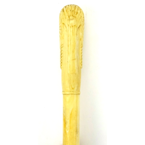 110 - Segmented ivory walking cane, the pommel carved in the form of an Egyptian bust, 90cm in length