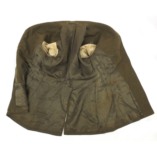 227 - British Military World War II uniform including tunics and a leather swagger stick