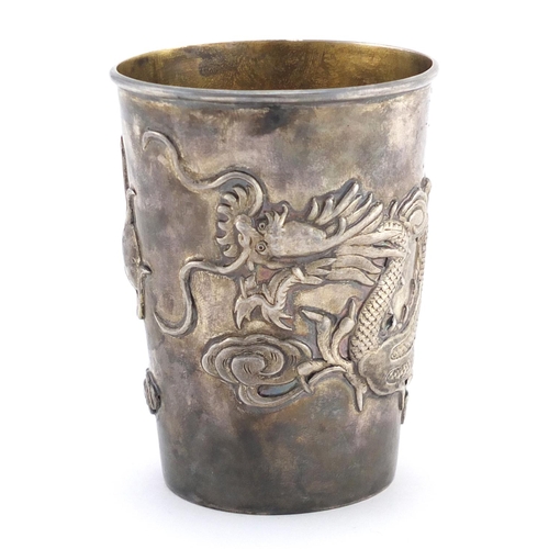 332 - Chinese silver cup and spoon, the cup with tapering body cast with a dragon chasing the flaming pear... 