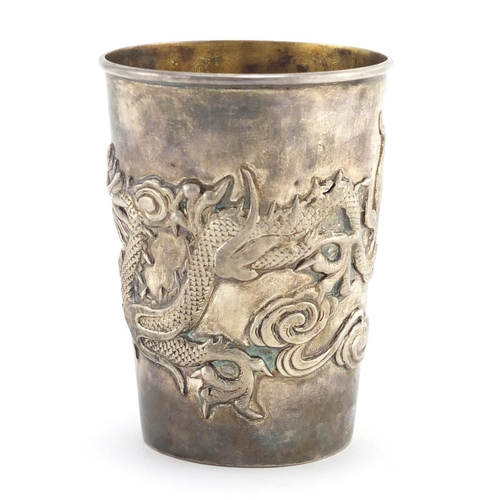 332 - Chinese silver cup and spoon, the cup with tapering body cast with a dragon chasing the flaming pear... 