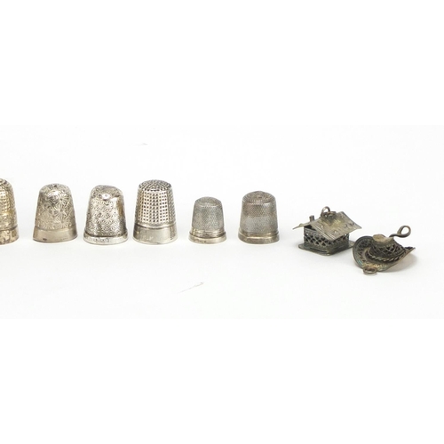 298 - Group of silver and white metal thimbles and charms