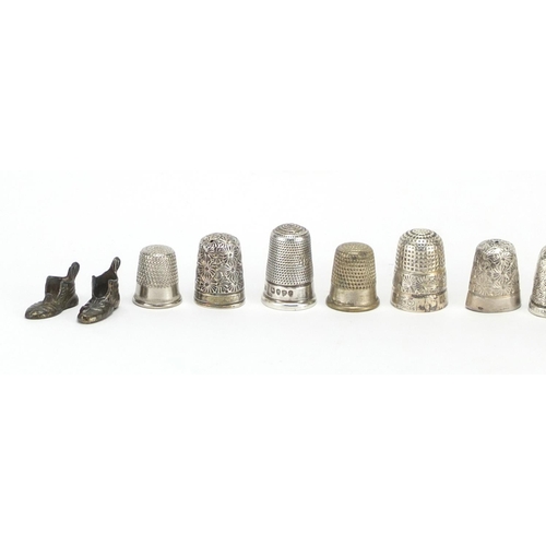 298 - Group of silver and white metal thimbles and charms