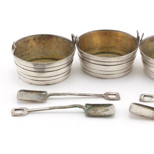 630 - Set of four silver plated barell shaped salts, with shovel spoons, housed in a velvet and silk lined... 