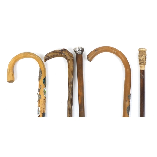 115A - Five walking sticks including a malacca type example with silver pommel and a Swiss example, the lar... 