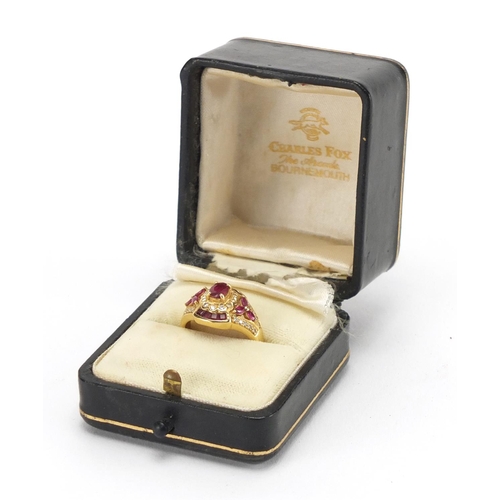 726 - 18ct gold ruby and diamond dress ring, housed in a Charles Fox Bournemouth tooled leather box, size ... 