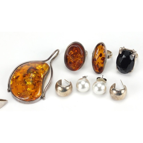 2853 - Mostly silver jewellery including a large natural amber pendant, amber rings and stylish earrings, a... 