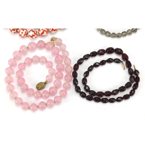 2855 - Four necklaces including Chinese porcelain beads and rose quartz