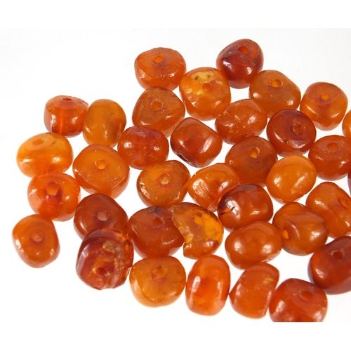 2859 - Loose amber coloured beads, approximate weight 33.0g