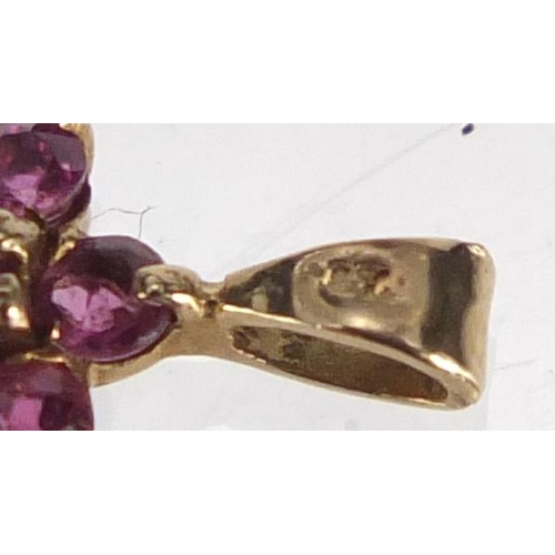 2832 - 9ct gold ruby flower head pendant, 1.2cm in length, approximate weight 0.5g
