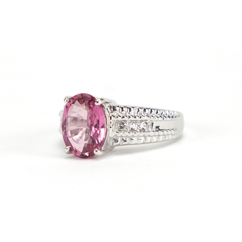 2653 - 9ct white gold pink stone ring set with clear stones to the shoulders, size N, approximate weight 5.... 