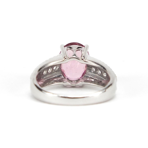 2653 - 9ct white gold pink stone ring set with clear stones to the shoulders, size N, approximate weight 5.... 