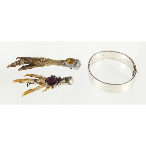 2827 - Two Scottish silver animal claw brooches set with citrine and amethyst together with a silver bangle... 