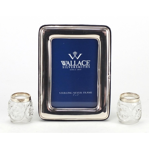 321 - Rectangular silver easel photo frame and a pair of glass salts with silver collars, the photo frame ... 