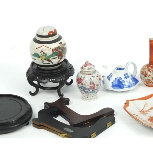 606 - Chinese and Japanese porcelain and woodenwares, including a blue and white teapot  and a Kutani bud ... 