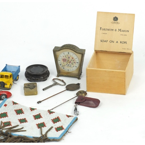 562 - Objects including a pair of African sequin cuffs, Dinky die cast vehicles, Zippo lighter and TMC hea... 