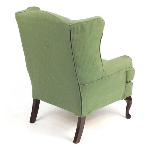 50 - Mahogany framed wingback armchair, with green and gold upholstery, 107cm high