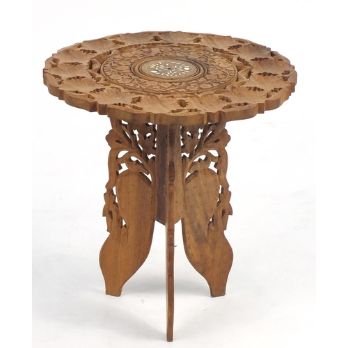 38 - Anglo-Indian folding table carved with leaves, 47cm high x 45cm in diameter