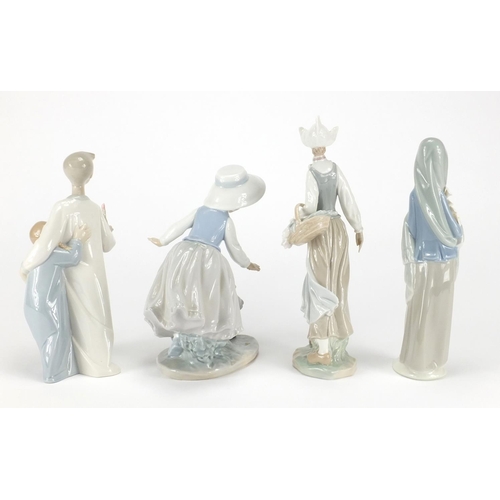 2239 - Three Lladro figuresand one Nao including a girl holding a basket of flowers and a young boy with  g... 