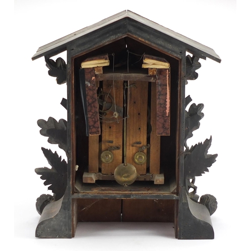 2045 - Black forest cuckoo clock carved with a bear, wolf and leaves, 50cm high