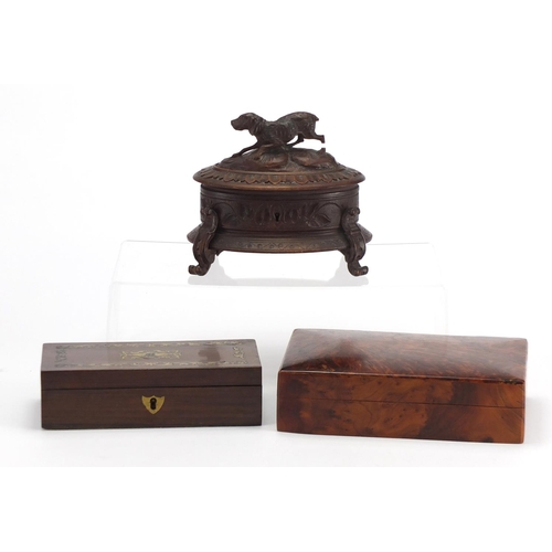 2245 - Woodenware including a black forest casket with carved dog finial and a rectangular rosewood pen box... 