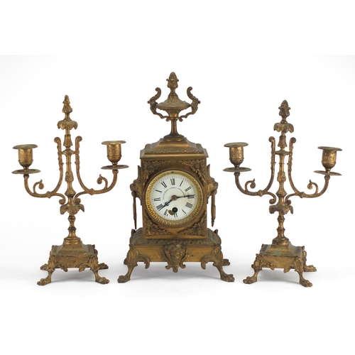 2260 - French three piece gilt brass mantel clock garniture, the mantel clock with lion mask handles and en... 