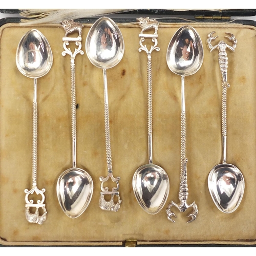 2580 - Set of six silver coloured metal teaspoons with elephant, lion and scorpion handles, housed in a Map... 