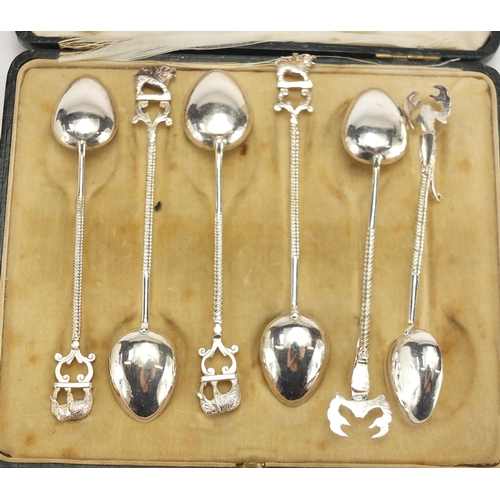 2580 - Set of six silver coloured metal teaspoons with elephant, lion and scorpion handles, housed in a Map... 