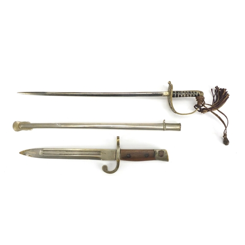 67 - Two Military interest letter openers in the form of a sword with scabbard and bayonet, the largest 2... 