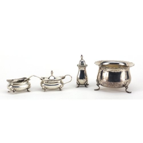 600 - Circular silver three footed bowl and silver three piece cruet, the bowl hallmarked Birmingham 1902,... 