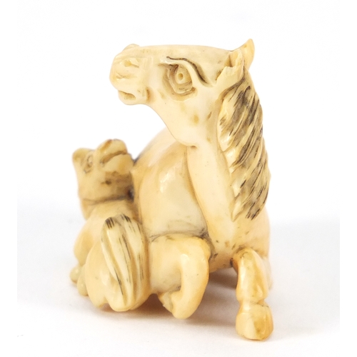 355 - Japanese carved ivory Netsuke of a horse and foal, incised marks to the underside, 4.2cm wide